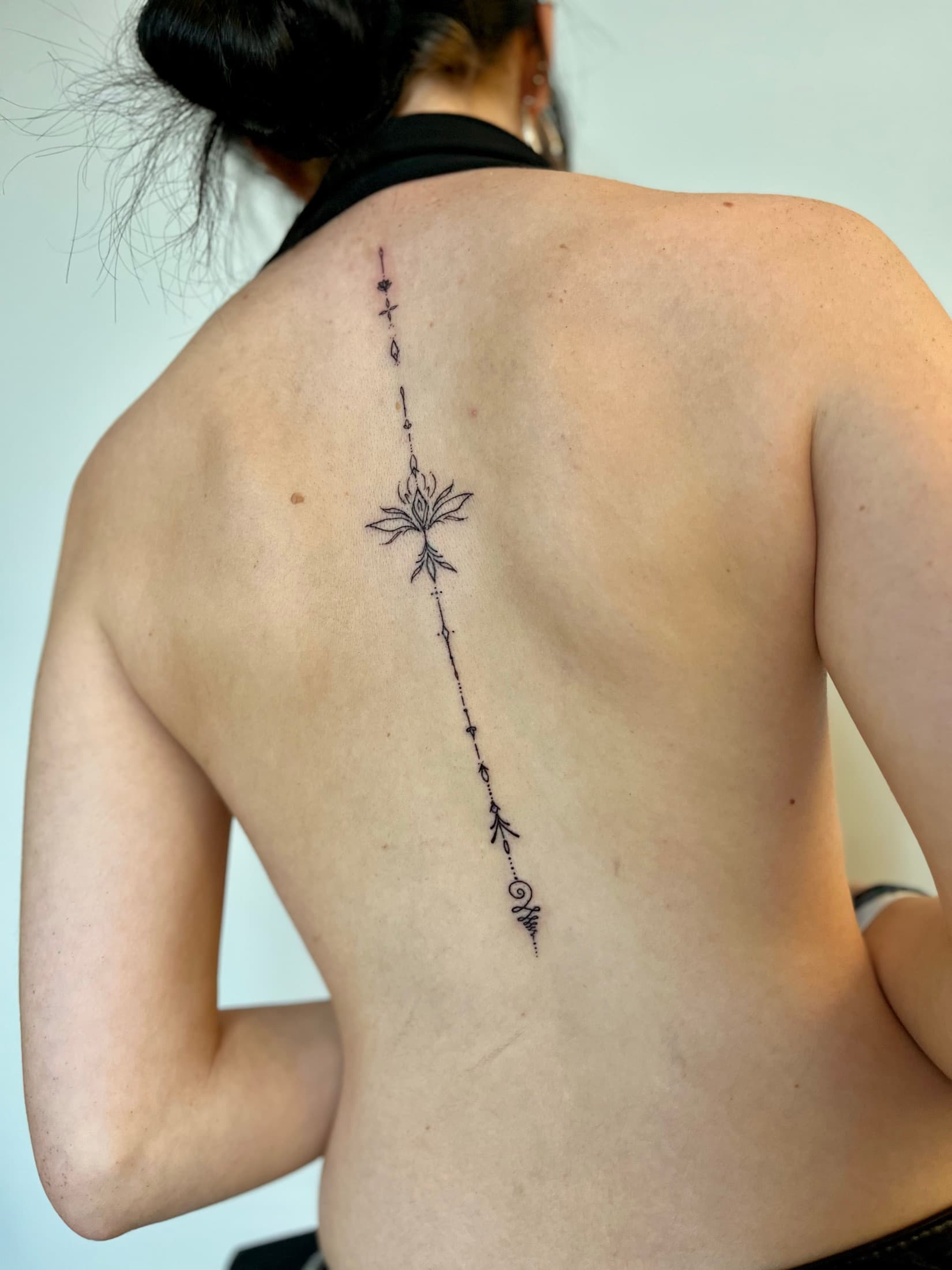Ornamental Fineline tattoo along the spine